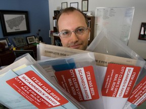 Councillor Mike Laytonholds up Toronto City Hall mail marked as scanned and X-rayed on Monday. The new packaging started showing up this week. (Stan Behal/Toronto Sun)