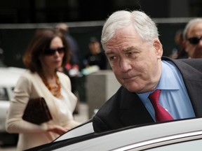 Conrad Black and his wife Barbara Amiel leave federal court in Chicago, June 24, 2011. (Reuters files)