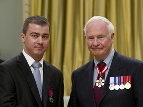 Gov. Gen. David Johnston presents the Medals of Bravery to George Rusu at a ceremony at Rideau Hall in Ottawa,  April 20, 2012. (Chris Roussakis/QMI Agency)