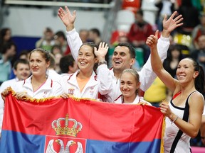 Serbia's (L-R) Bojana Jovanovski, Ana Ivanovic, team captain Dejan Vranes, Aleksandra Krunic and Jelena Jankovic pose for a picture as they celebrate their victory over Russia in their semi-final match at the Fed Cup tennis tournament in Moscow April 22, 2012. REUTERS/Grigory Dukor