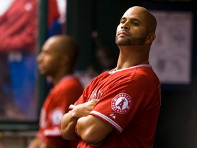 Los Angeles Angels' Albert Pujols (right) watches from the dugout during ninth inning MLB action against the Tampa Bay Rays in St. Petersburg, Fla., on April 24, 2012. (Steve Nesius/Reuters)