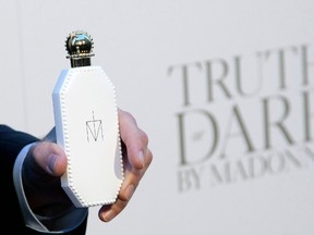 A bottle of "Truth or Dare by Madonna"  is presented to the media before the arrival of Madonna at Macy's in New York April 12. 2012.  (REUTERS/Andrew Kelly)