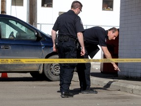 Edmonton Police Service forensics members investigate at the scene of an early morning shooting near 107 Avenue and 104 Street, Monday May 7, 2012.  (DAVID BLOOM/EDMONTON SUN)