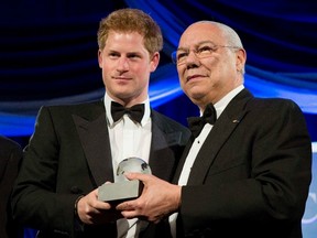 Prince Harry stands with former U.S. Secretary of State Colin Powell as he receives the Humanitarian Award from the Atlantic Council during their annual awards dinner in Washington May 7, 2012. (REUTERS/Joshua Roberts)