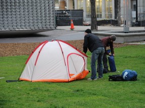 One of the only two Occupy campers remaining in Winnipeg's Old Market Square packs up their belongings shortly after 6:30 Friday morning, May 11, 2012. (STEPHEN RIPLEY/Winnipeg Sun)