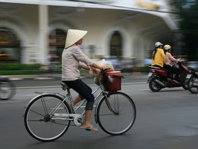 A photo of a cyclist in Ho Chi Minh City, Vietnam. A Canadian tourist has died in Vietnam, the Foreign Affairs department confirmed Saturday. (Shutterstock)