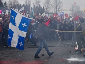 Students confront riot police during a protest against hikes in tuition on May 4, 2012 as the annual Liberal Convention is being held in Victoriaville, Quebec, Canada. (AFP PHOTO/ROGERIO BARBOSA)
