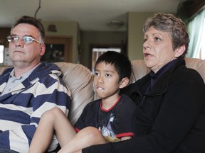 Charlotte Seehawer, her son Samuel Seehawer, 7, and her husband Mark chat with QMI Agency in their home in Calgary, April 27, 2012. Samuel was adopted from an orphanage in Cambodia and has navigated life well with three congenitally amputated limbs. (Lyle Aspinall/QMI Agency)