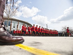 Members of the Surrey RCMP dressed in their red serge uniforms stand at attention during a ceremony in Surrey, BC. a municipality in the Metro Vancouver area May 1,  2011. photo by CARMINE MARINELLI / QMI AGENCY