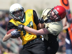 Winnipeg Nomads Wolf Pack running back Jill Fast (left) breaks a tackle by Manitoba Fearless DB Pauline Olynik to score a touchdown during Western Women's Canadian Football League action at East Side Eagles Field in Winnipeg on Sunday, May 13, 2012. Manitoba Fearless won 34-22 in the opening game of the second WWCFL season for both teams.