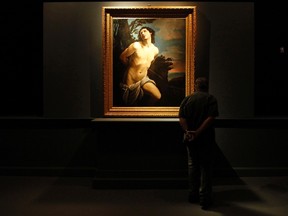 A visitor admires St. Sebastian, a painting by 17th century master Guido Reni, on show in the Vatican's Braccio Carlo Magno exhibition space in St Peter's Square at the Vatican May 16, 2012. REUTERS/Giampiero Sposito