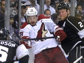 Phoenix Coyotes right wing Shane Doan is checked along the boards by Los Angeles Kings defenceman Matt Greene in the second period during Game 3 of the NHL Western Conference final hockey playoffs in Los Angeles, California, May 17, 2012. (REUTERS)