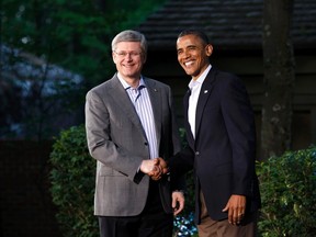 U.S. President Barack Obama (R) greets Canada’s Prime Minister Stephen Harper as he arrives at the G8 Summit at Camp David, Maryland May 18, 2012. REUTERS/Chris Wattie