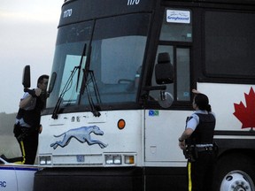 Mounties look into the bus where Tim McLean was brutally murdered by Vince Li on July 30, 2008. To prevent a similar tragedy from occurring in the future, Li should never be released from the Selkirk Mental Health Centre. (QMI Agency files)