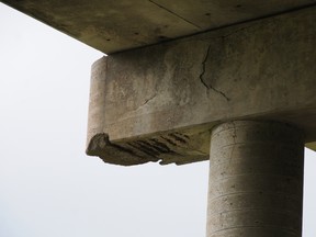 An abutment on the CN Rail overpass on Bay Bridge Road shows its age with crumbled concrete exposing rebar beneath.