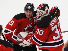 Devils goaltender Martin Brodeur is congratulated by teammate Zach Parise after defeating the Rangers in Game 4 of the NHL Eastern Conference final at the Prudential Center in Newark, N.J., May 21, 2012. (ADAM HUNGER/Reuters)