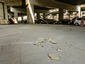 Debris from the Gardiner Expwy. lays on the sidewalk along Simcoe St. at the northeast corner of Lakeshore Blvd. in this May 22, 2012 file photo. (Toronto Sun files)