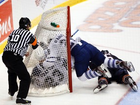 Matt Frattin takes a hit from Jerry D'Amigo after scoring the Marlies' third goal in a 3-1 defeat of the Oklahoma City Barons during Game 5 of their Western Conference Final at the Ricoh Coliseum on Friday, May 25, 2012. (MICHAEL PEAKE/TORONTO SUN)