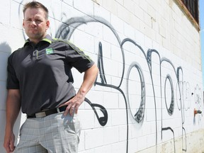 W. BRICE MCVICAR The Intelligencer
Coun. Jodie Jenkins stands along the south wall of the Stewart Warner building on MacDonald Avenue. The warehouse has been the ongoing target of graffiti artists for the past three years.