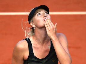 Russia's Maria Sharapova reacts after winning over Czech Republic's Petra Kvitova during their Women's Singles semifinal tennis match of the French Open tennis tournament at the Roland Garros stadium, on June 7, 2012 in Paris. (Thomas Cox/AFP)