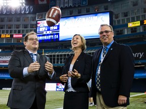 Councillor Karen Stintz on the field at Rogers Centre before a 2012 pre-season game against hte Montreal Alouettes. On the left is Toronto Sun Publisher Mike Power and the Toronto Argonauts' senior VP of business operations Dave Bedford is on the right. (Ernest Doroszuk/Toronto Sun)