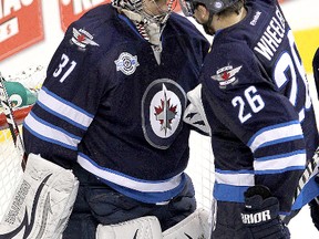 Winnipeg Jets right winger Blake Wheeler (right) pats goalie Ondrej Pavelec followig the Jets 3-2 victory over the Washington Capitals in NHL hockey in Winnipeg Friday, March 16, 2012.