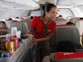 A VietJetAir flight attendant serves passengers during a flight from Hanoi to Ho Chi Minh city  March 2, 2012. REUTERS/Kham