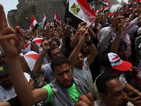 Supporters of Muslim Brotherhood's presidential candidate Mohamed Morsy chant slogans during a rally against the delay of the Egyptian presidential results and against the Supreme Council for the Armed Forces (SCAF) at Tahrir Square in Cairo June 22, 2012. (REUTERS/Amr Abdallah Dalsh)