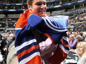 Mitchell Moroz, 32nd overall pick by the Edmonton Oilers, puts on a jersey during day two of the 2012 NHL Entry Draft at Consol Energy Center on Saturday in Pittsburgh, Penn.
Bruce Bennett/Getty Images/AFP