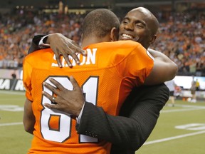 BC Lions slotback Geroy Simon (left) hugs previous record holder Milt Stegall while celebrating breaking the CFL all-time receiving record against the Winnipeg Blue Bombers during the second half of their CFL football game in Vancouver, on Friday, June 29, 2012.
