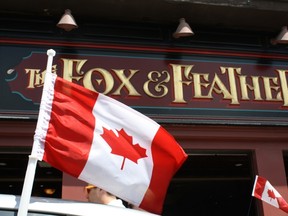 Canadian flags hung from a parked car were the only Canada Day apparel getting anywhere near the Fox and Feather pub on Sunday. The bar's owners banned all staff from wearing red and white, painting their faces or bringing Canadian flags in to work.
MICHAEL AUBRY//OTTAWA SUN/QMI AGENCY