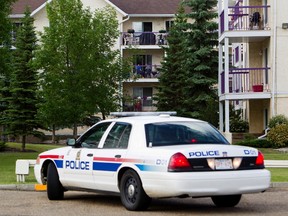 A police cruiser sits in front of Pointe II apartment complex, 10636 120 St., where one woman was found dead and at least five others were taken for treatment on Sunday. AMBER BRACKEN/EDMONTON SUN