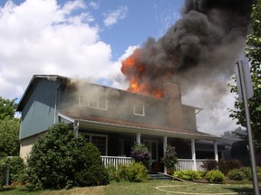 Flames shoot out the roof of 141 Withrow Ave. Sunday, July 1, 2012. The fire was one of five over the holiday weekend, causing 20 people to be forced from their homes.
SCOTT STILLBORN/Ottawa Fire Service