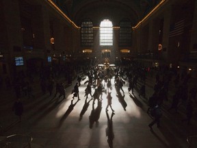 Morning commuters are silhouetted as they walk through the main concourse of the Grand Central Terminal, also known as Grand Central Station, in New York in this March 5, 2012 file photo. REUTERS/Adrees Latif/Files