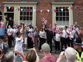 The Olympic torch passes the birthplace of William Penny Brookes the founding father of the modern Olympics in Much Wenlock, central England, May 30, 2012. REUTERS/Darren Staples/files