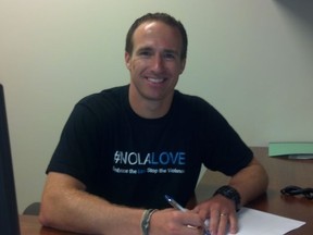 Drew Brees posted this photo of himself to his Twitter account Sunday with the tweet: "Just made it official. Contract is signed! ‪#NOLALOVE"