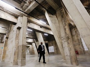A worker walks through The Tanks, new galleries within the Tate Modern art gallery in London July 16, 2012. (REUTERS/Luke MacGrego)