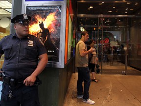 A policeman stands outside a movie theater in New York on July 20, 2012 during a showing of "The Dark Knight Rises." New York Police Commissioner Ray Kelly announced that the New York Police Department would provide police protection "as a precaution against copycats" following a shooting during a midnight screening of the film in Aurora, Colorado, which left 12 people dead and at least 50 injured. AFP PHOTO/Mehdi Taamallah
