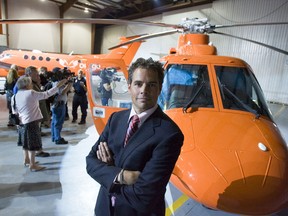 Dr. Chris Mazza poses in front of an Ornge helicopter at during the unveiling of the new brand for the air ambulance service at the Toronto Island airport on Aug. 28, 2006