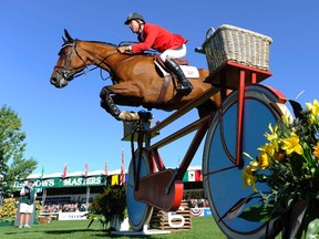 Ian Millar jumps on his horse Star Power during the Spruce Meadows Nations' Cup horse jumping event in Calgary, Alberta, September 10, 2011.  REUTERS/Todd Korol