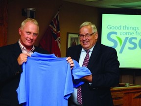 Sysco Central Ontario president Rodney Stroud (left) celebrates with Woodstock Mayor Pat Sobeski after Thursday's official announcement that Sysco is building a 400,000-square-foot food distribution centre in the Friendly City.