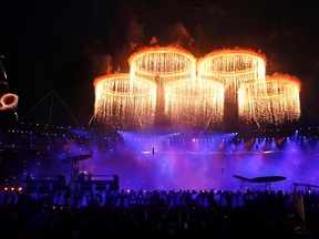 The Olympic rings are seen during a pyrotechnics display at the pre-show before the opening ceremony of the London 2012 Olympic Games at the Olympic Stadium July 27, 2012. (Suzanne Plunkett/REUTERS)