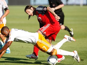 Toronto FC's Torsten Frings (rear) battles with the Houston Dynamo's Luiz Camargo during the second half of their MLS soccer match in Toronto last week. The Reds begin CONCACAF Champions League action tonight against El Salvador's Aguila. (REUTERS)