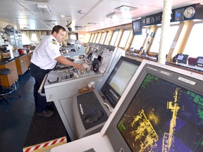 Captain Seann O'Donoughue tweaks the controls in the wheel house aboard his cargo ship Algoma Spirit. BILL HENRY/The Sun Times/QMI Agency.