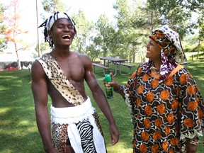 African Pavillion member Reckie Lloyd gets some bug spray from Nyambury Queen during a Heritage Festival news conference at Hawrelak Park on Aug1, 2012.  The festival runs from Aug. 4-6, 2012 at Hawrelak Park.  PERRY MAH/EDMONTON SUN  QMI AGENCY