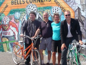City Coun. Rick Chiarelli, Frank Dinardo and Sue Berger of Dinardo's Skis & Wheels, and Alex Lewis, executive director of the Bells Corners BIA, unveiled a new mural at Dinardo's Skies & Wheels Thursday. The mural was funded in part from a grant from the City of Ottawa to prevent and clean up graffiti in the city. (MARLO CAMERON /OTTAWA SUN/QMI AGENCY)
