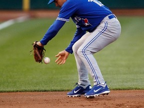 Toronto Blue Jays third baseman Omar Vizquel bobbles a ground ball and is unable to make an out during the second inning of their MLB baseball game against the Oakland Athletics in Oakland August 3, 2012. (Reuters/BECK DIEFENBACH)