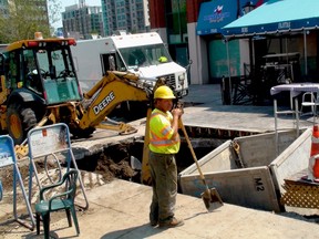Saturday, Aug. 4, 2012, Ottawa -  A worker surveys the site of a water main break in the Byward Market on Saturday afternoon. Staff at the Lone Star Texas Grill were forced to close the Dalhousie and George streets eatery Friday night after finding water in the basement. The restaurant was to reopen Saturday evening. (TONY SPEARS/OTTAWA SUN/QMI AGENCY)