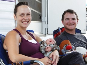 Karen Manning holds newborn Aiden alongside his father Ryan at her parent's campsite at Big Valley Jamboree in Camrose, Alberta, on Aug. 4, 2012. The baby has been dubbed the youngest fan at Big Valley. IAN KUCERAK/EDMONTON SUN/QMI AGENCY