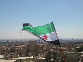 An opposition flag is seen over neighborhood Ruknuddin in Damascus August 5, 2012. Picture taken August 5, 2012. REUTERS/Shaam News Network/Handout